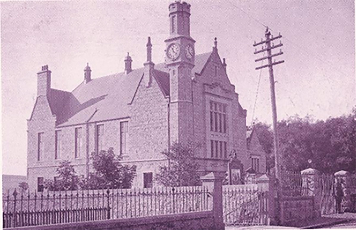 The Victoria Hall with the hall keeper outside the gate from the 1910